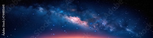Nebulous Clouds and Stars in a Dark Blue Sky over a Horizon Illuminated by a Red Glow