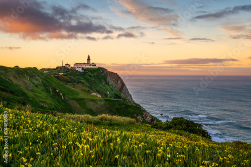 View of the Cabo da Roca lighthouse. Sintra, Portugal. Cape Cabo da Roca, the westernmost point of Europe. Beautiful sunrise at the coast near Lisbon.  photo