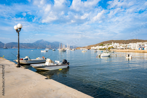 View of Adamas port and fishing boats on sea, Milos island, Cyclades, Greece photo