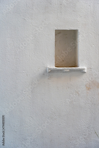 White wall background with a niche in city Udaipur, Rajasthan, India. Closeup, copy space