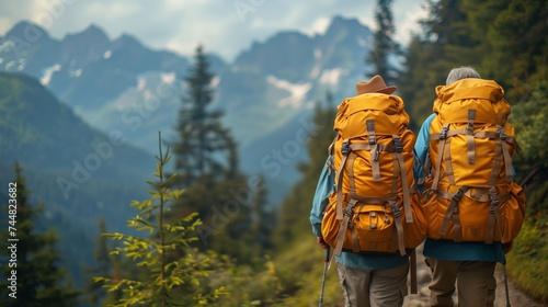 Two hikers with backpacks on mountain trail in stunning natural landscape