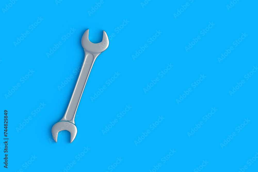 Spanner on blue background. Metal wrench in workshop. Repair and maintenance tool. Top view. Copy space. 3d render