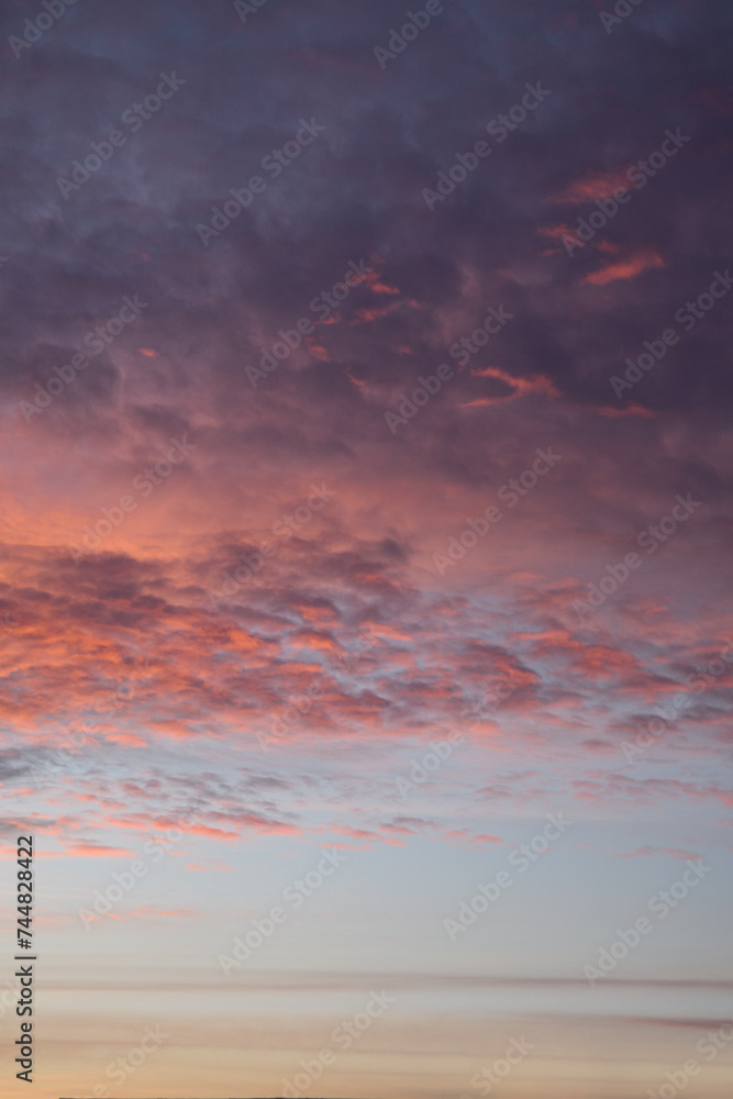 Layers of sunset. Fluffy clouds. Romantic sky. Universal vertical photo. The background picture.