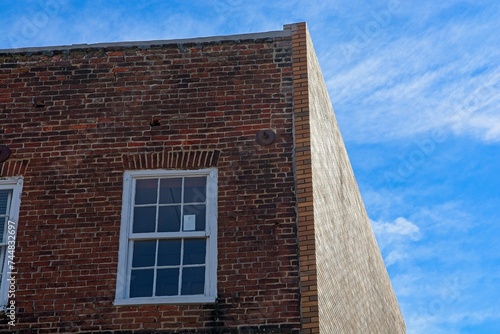Brick building with  jack arch window lintel against blue sky