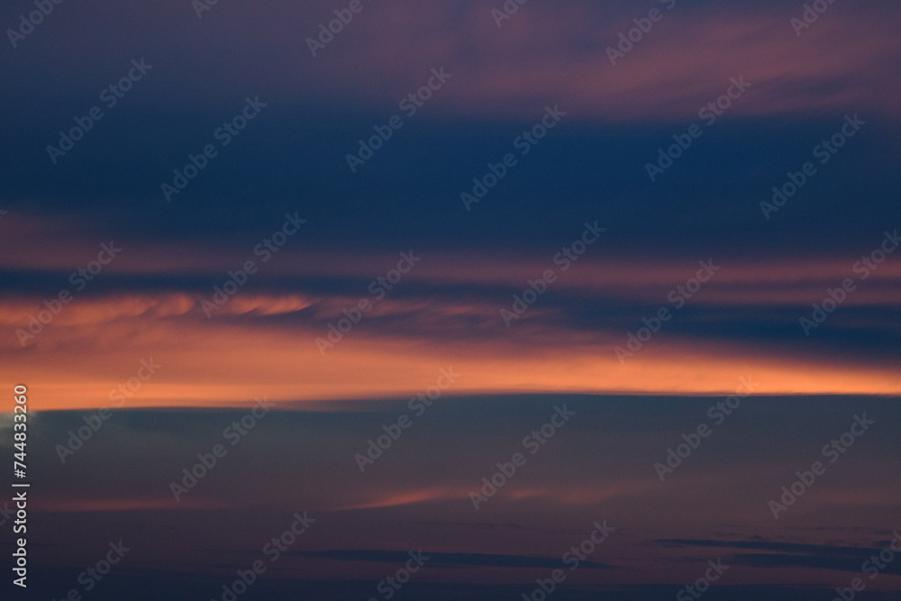 Bright blue clouds at sunset. Yellow lines, romantic sky. Light breaks through the clouds. Universal photos. The background picture. Bright blue clouds at sunset. Yellow lines, romantic sky. Light breaks through the clouds. Universal photos. The background picture.