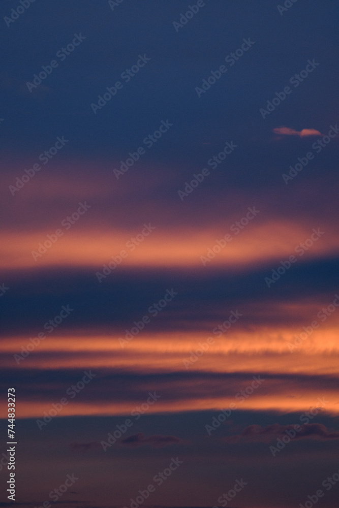 Bright blue clouds at sunset. Yellow lines, romantic sky. Light breaks through the clouds. Universal photos. The background picture.