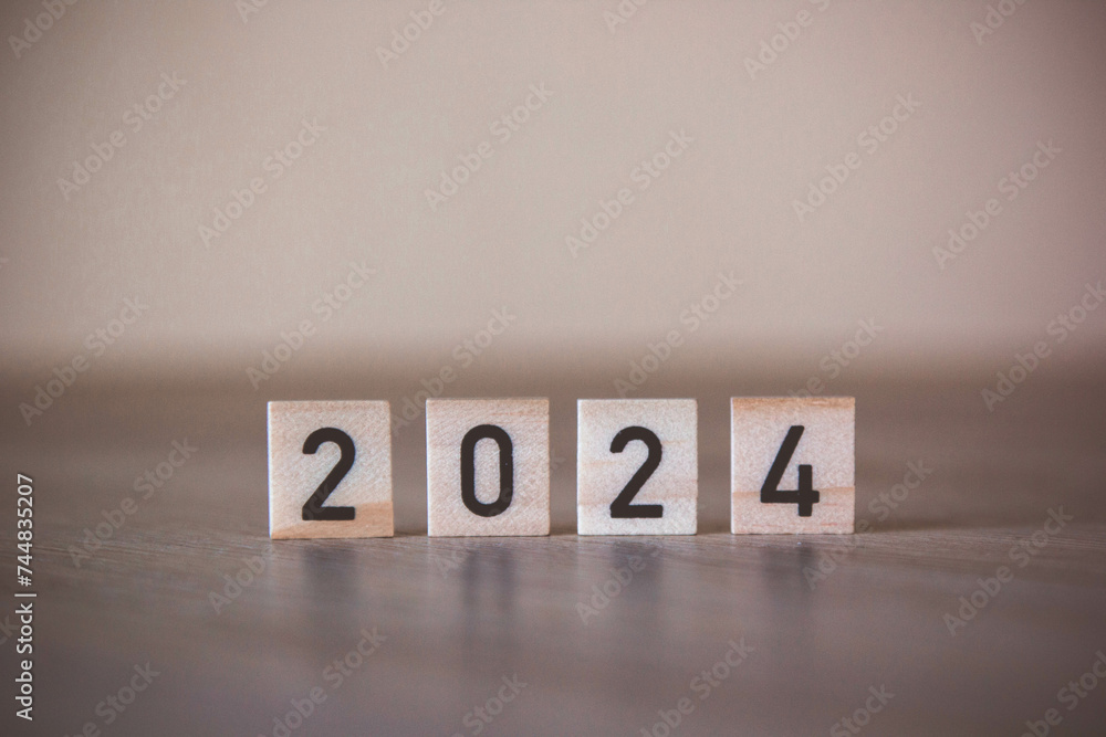 word 2024 written on wood. 2024. Year. Business plan in 2024. objective and goals. 2024 on wooden cubes. Economy, business and financial concept. New Year's concept word 2024 written on wood. 2024. Year. Business plan in 2024. objective and goals. 2024 on wooden cubes. Economy, business and financial concept. New Year's concept