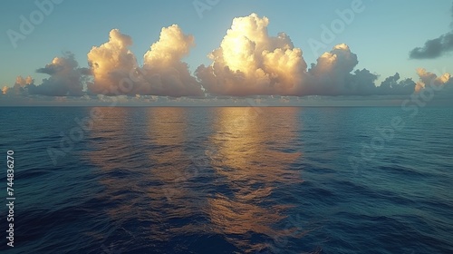 Serene ocean landscape with fluffy white clouds reflected on the calm sea at dusk, symbolizing tranquility and the beauty of marine nature photo