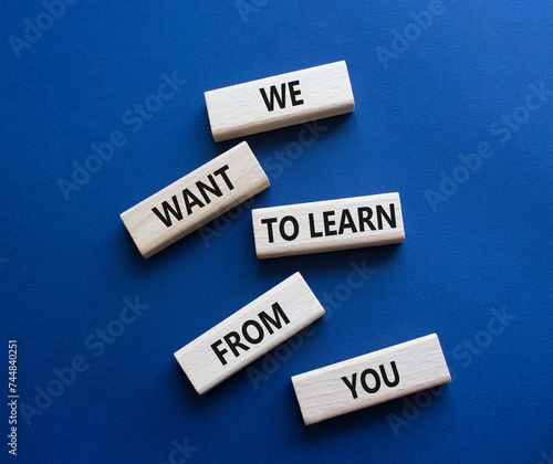 We want to learn from you symbol. Wooden blocks with words We want to learn from you. Beautiful deep blue background. Business and We want to learn from you. Copy space.