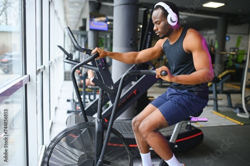 healthy african american man exercising in gym