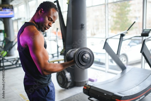 African American man working out in the gym. © Serhii