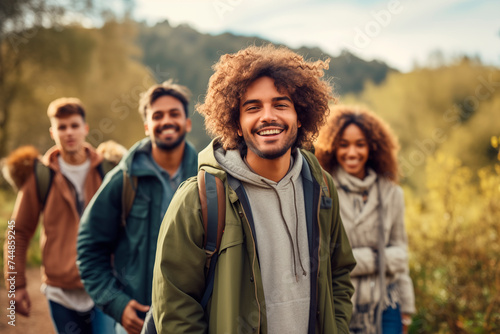  Cheerful group of friends hiking together in a forest trail.