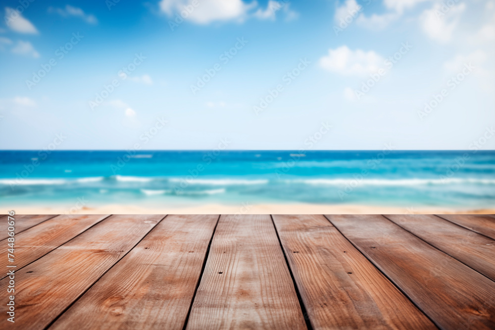 A wooden deck in the foreground with a clear view of the tranquil blue ocean and horizon.
