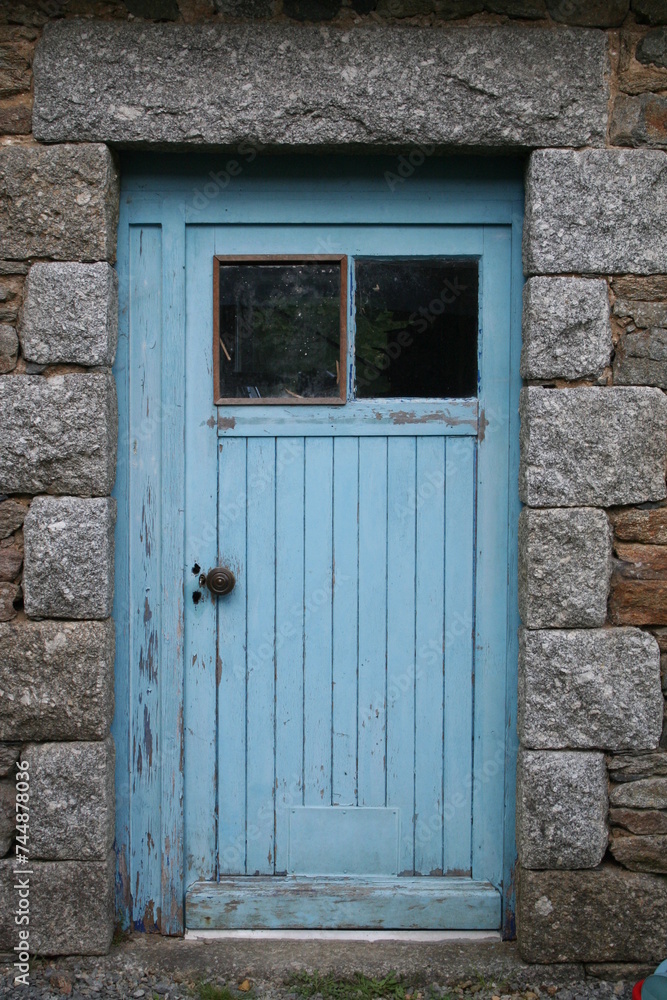 old wooden door in a granit stone wall
