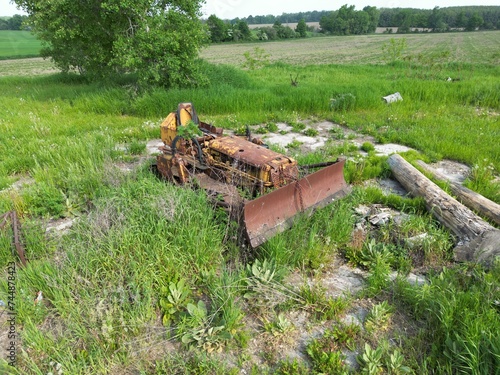 Canvas Print old buldozer in a field