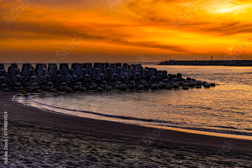 Stunning sunset blues hour view. Magnificent, beautiful breakwater, red cloudy sky form a scenic scene.High quality photo. Linyuan, Kaohsiung, Taiwan.For branding, screensavers, websites, postcard. photo