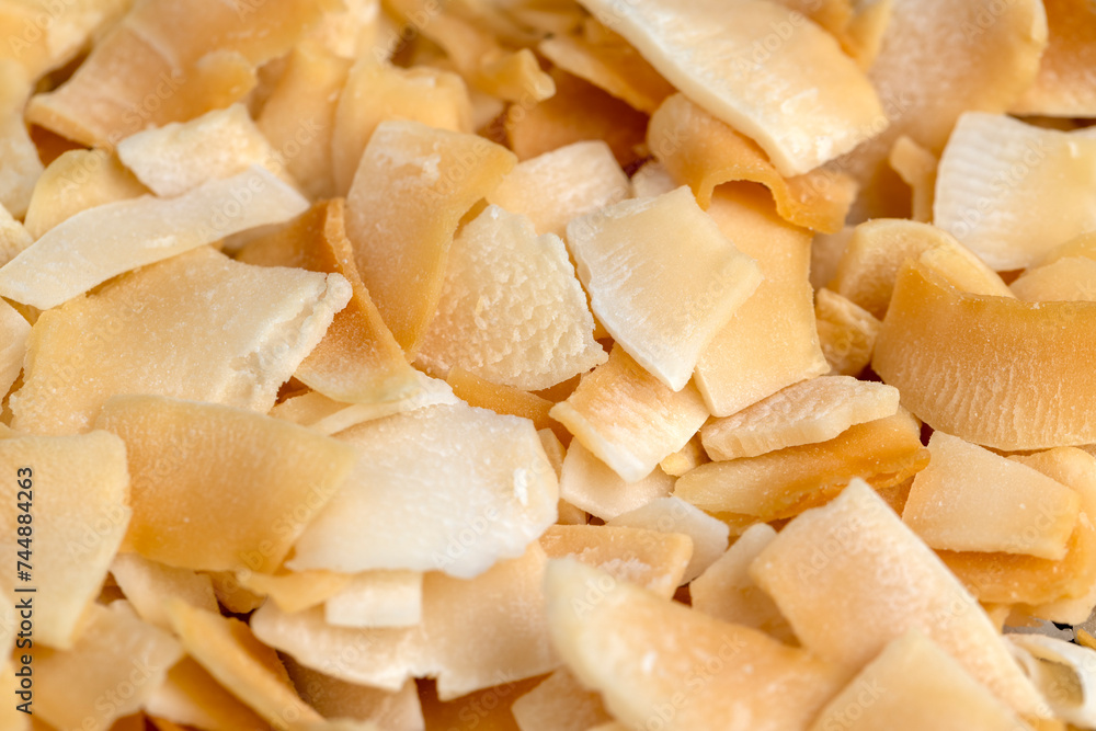 sweet orange and yellow coconut flakes fried in sugar sweet orange and yellow coconut flakes fried in sugar