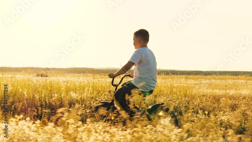 happy boy learning ride bicycle park, child schoolboy son rides bicycle sunset, happy family, cardio exercise machine, healthy active game child schoolboy sunset, spin wheel, turn foot pedal, son