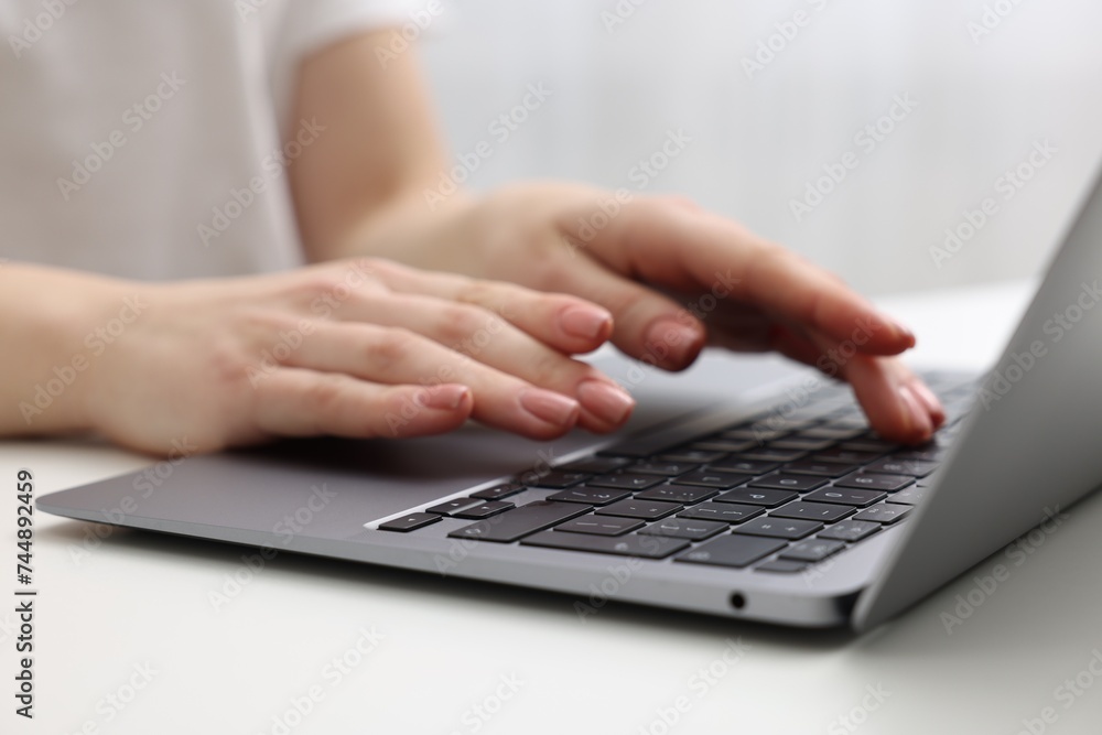 E-learning. Woman using laptop at white table indoors, closeup E-learning. Woman using laptop at white table indoors, closeup
