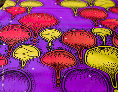 top view of purple ankara fabric, flatlay of nigerian wax cloth with designs, spread out purple ankara material photo