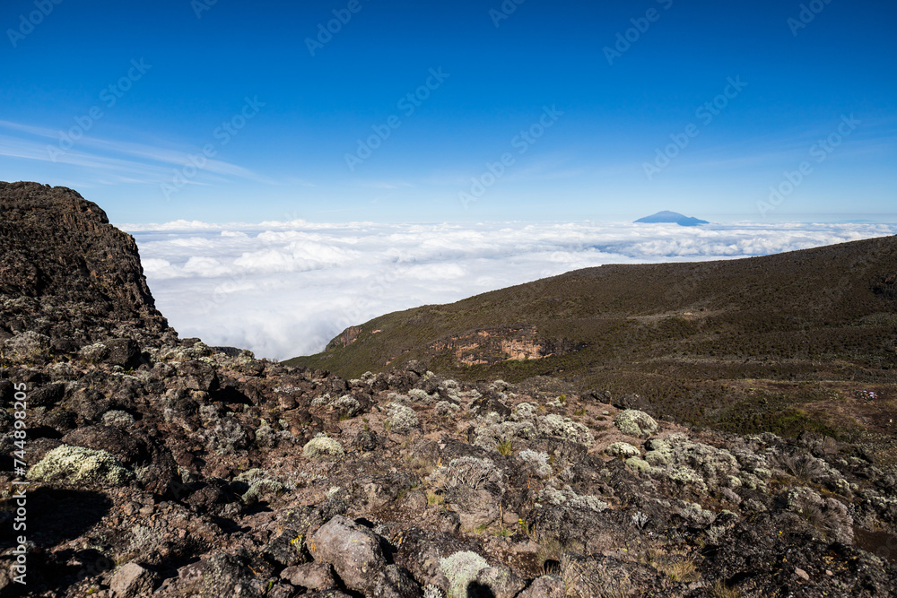 Elevated Majesty: Kilimanjaro’s Peak Overlooking Distant Mt. Meru