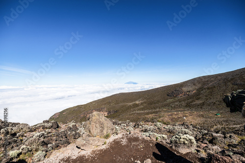Elevated Majesty: Kilimanjaro’s Peak Overlooking Distant Mt. Meru