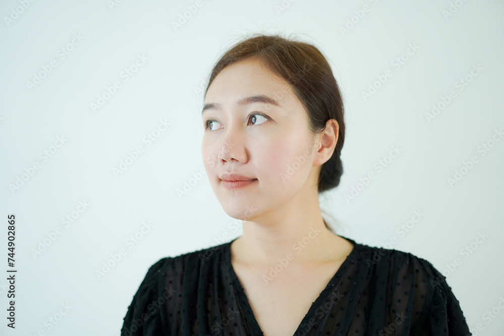 Smart - good looking Asian young adult woman in black shirt portrait.