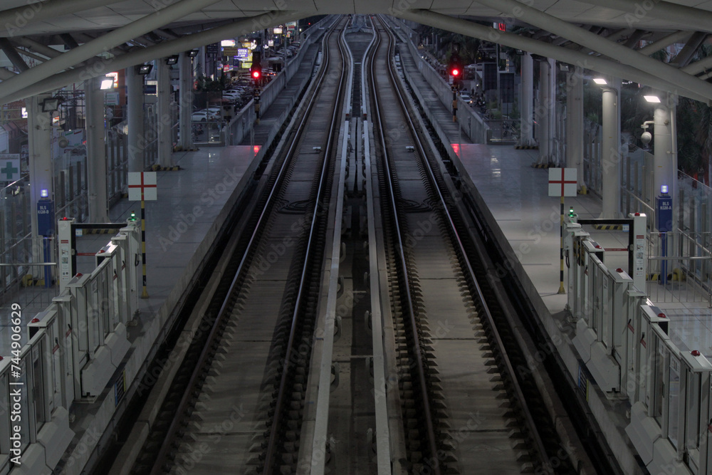 the atmosphere of the train tracks at the light rapid transit station along with signals as a guide
