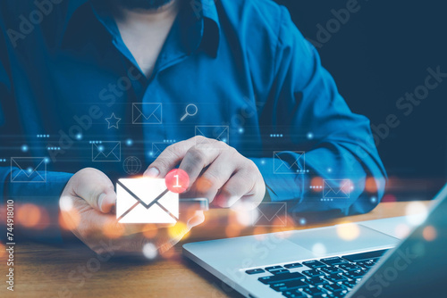 Email marketing, Businessman sending email by laptop computer to customer, Inbox receiving electronic message alert, email icon, email marketing concept, send e-mail or newsletter, Email concept. photo