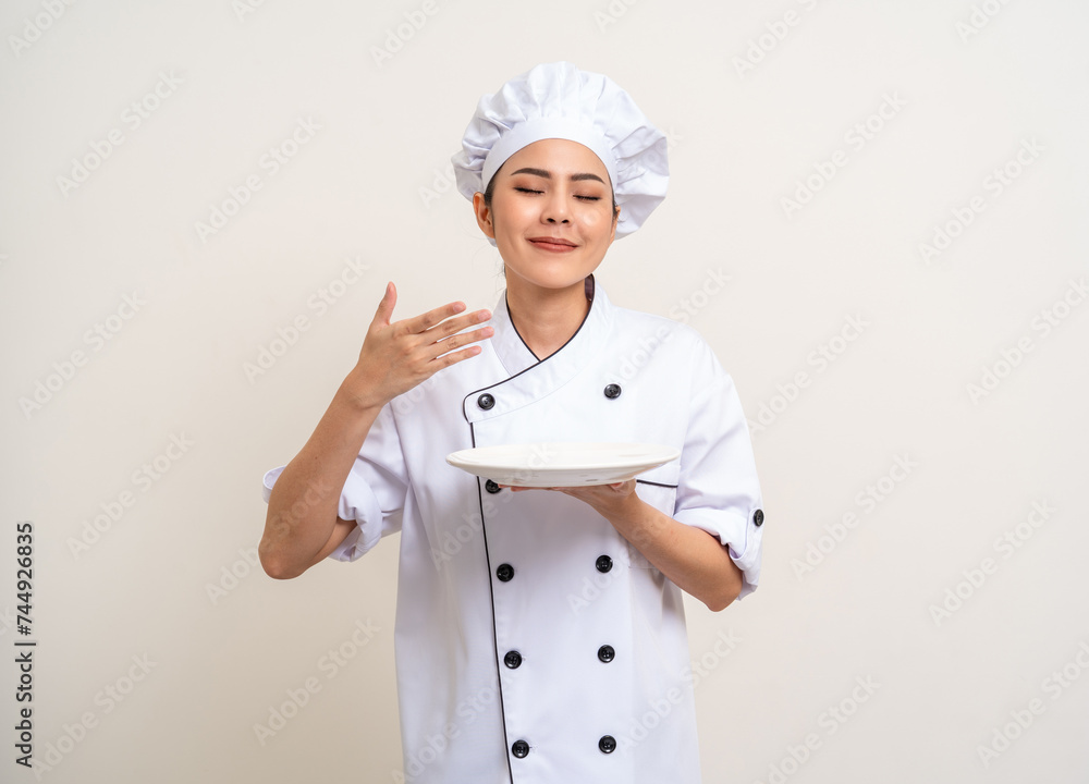 Smell the food. Beautiful asian woman chef in uniform holding plate ladle utensils cooking in the kitchen various gesture menu good taste on isolated. Cooking woman chef people in kitchen restaurant Smell the food. Beautiful asian woman chef in uniform holding plate ladle utensils cooking in the kitchen various gesture menu good taste on isolated. Cooking woman chef people in kitchen restaurant