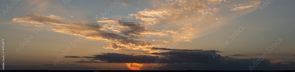 Landscape at sunset. Tragic gloomy sky. Panorama. Crimson twilight.