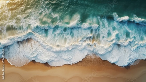 Aerial view of a beautiful sandy beach with blue ocean waves.