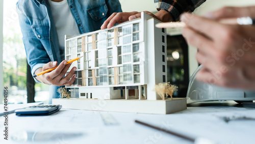 Fotografi Group of engineer is discussion and brainstorming about condominium model of con