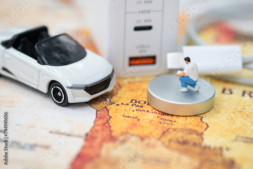 Miniature Figures and Electric Car Charging Station.