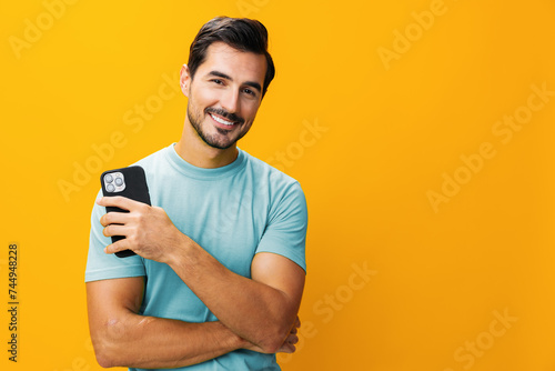 Man phone smiling studio technology phone communication smartphone happy mobile yellow portrait cyberspace copy space