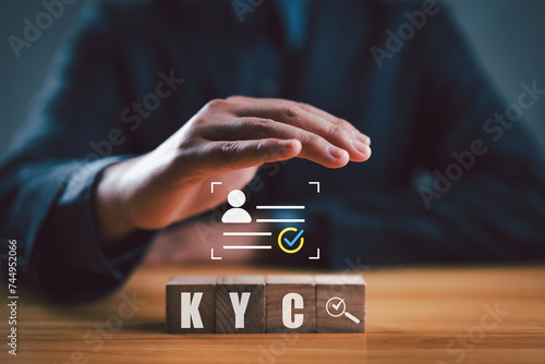 KYC on wooden cubes. know your customer with magnifying glass and customer information. Business verifying the identity of its clients concept.. photo