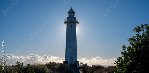 冬の低い太陽と岬に建つ灯台 photo