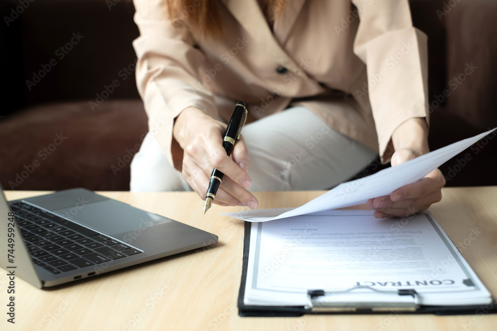 Fototapeta premium Business woman employer holding resume hiring recruit looking cv resume to hire candidates, analyzing information before job interview. Recruitment concepts