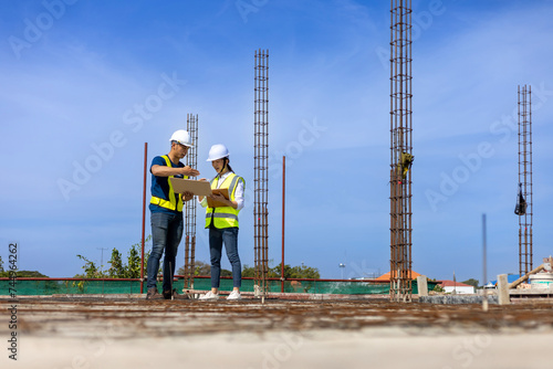Team of engineering architect inspector and contractor having discussion while examining the quality of construction work of real estate development project