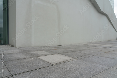 empty concrete floor in front of modern buildings in the downtown street. copy space for parking lot.