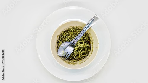 spinning or display rotating of a bowl of rawon flavored instant noodles with black sauce isolated on white background photo