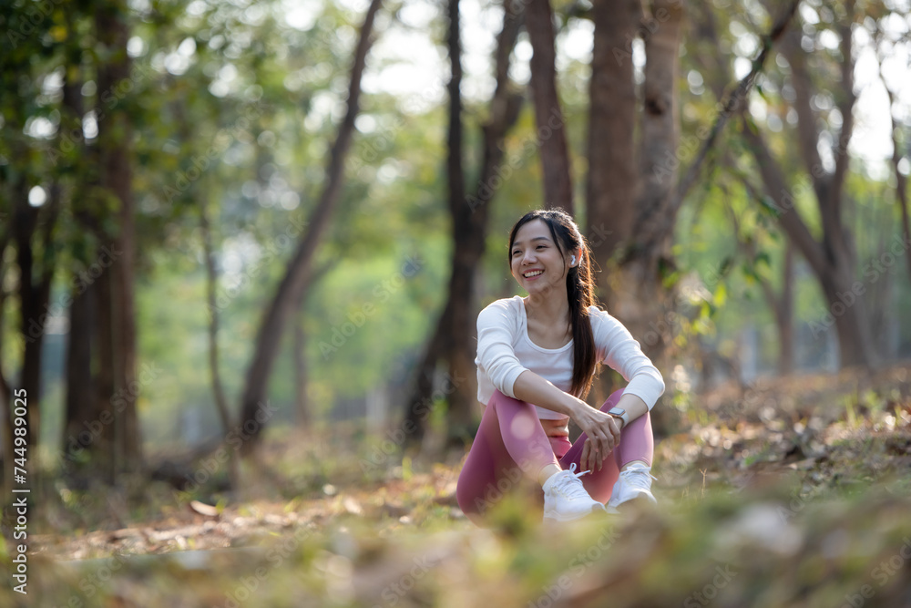 A young woman sits on the road to rest after jogging. A young woman sits on the road to rest after jogging.
