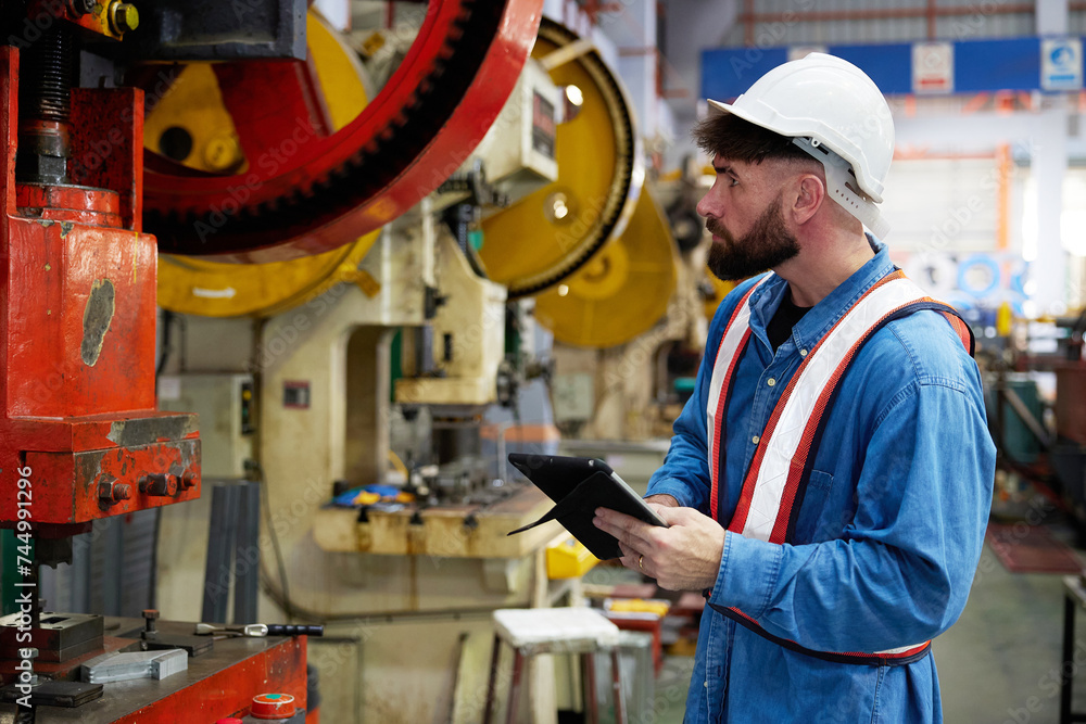 worker or engineer working on tablet and checking machine in the factory worker or engineer working on tablet and checking machine in the factory