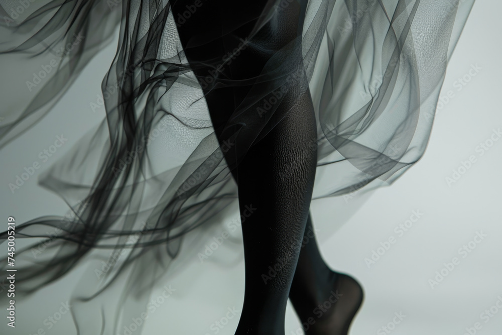 Legs of a beautiful woman wearing black tights , pantyhose fashion studio shot