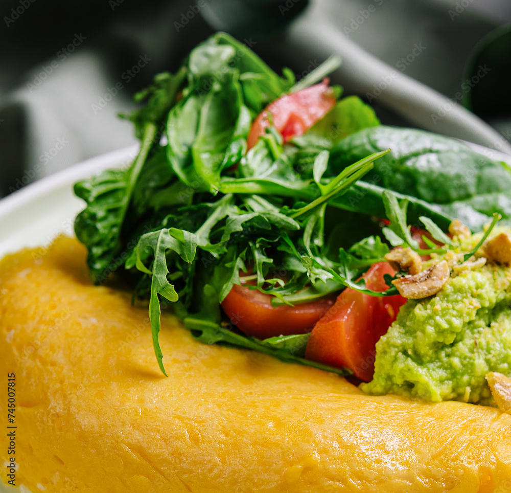 Omelette Served with Avocado puree and Cherry Tomatoes close up Omelette Served with Avocado puree and Cherry Tomatoes close up