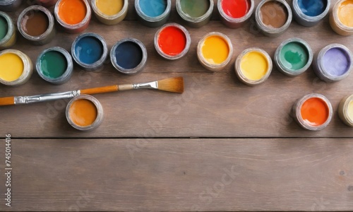 Art creative table background with watercolor paints palette paintbrushes tools on wooden desk, artist gray design blank workspace top view from above, flat lay