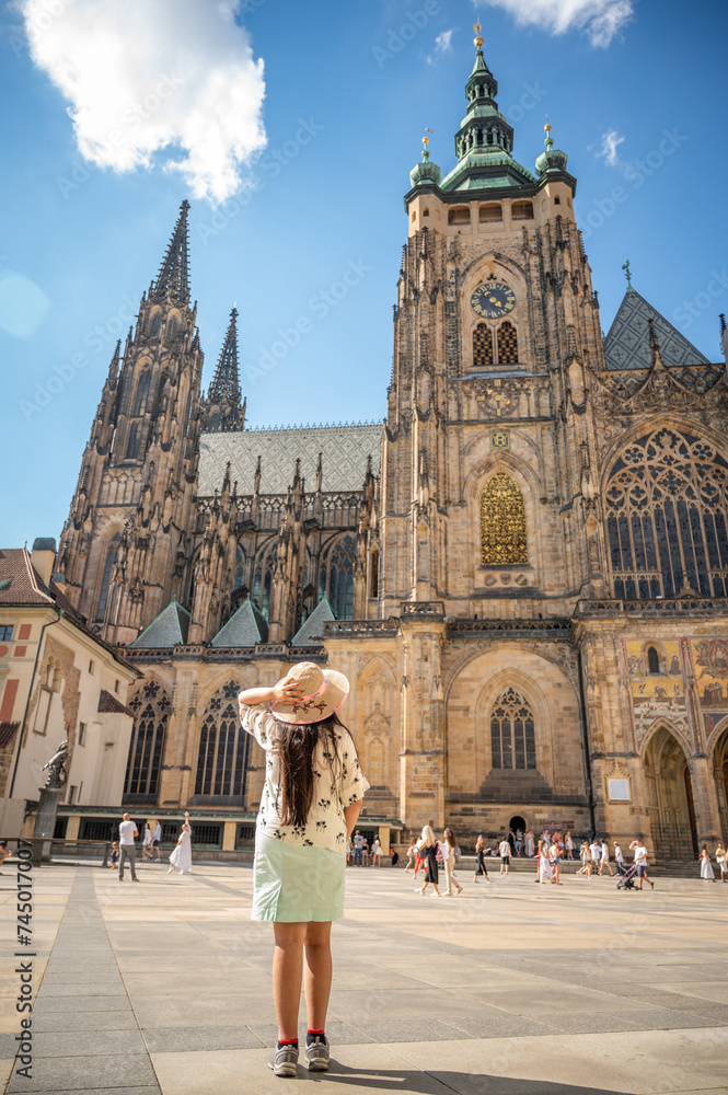 A beautiful woman in front of St. Vitus Cathedral at Prague Castle in Prague