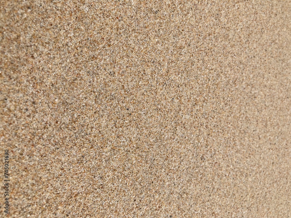 full frame close-up shot of clear brown wet sand on the beach in natural daylight, using for background full frame close-up shot of clear brown wet sand on the beach in natural daylight, using for background