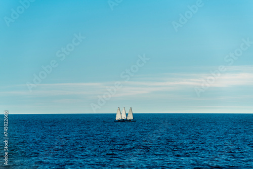 Three small sailing boats sailing on the sea