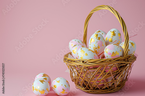 gold decorated white Easter eggs in wicker basket close-up on pink background. Easter card